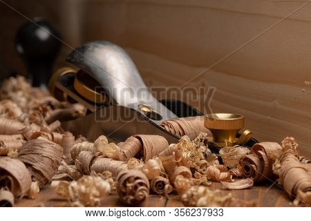 Small Block Plane With Wood Shavings On The Workbench