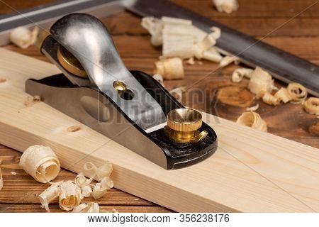 Chisel And Small Block Plane With Wood Shavings