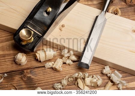 Chisel And Small Block Plane With Wood Shavings