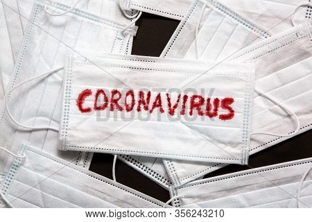 Concept Of A Coronavirus Pandemic.medical Disposable Face Mask With Covid-19 Printed On It. Covid-19