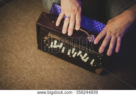 The Hands Of A Person Playing A Musical Instrument