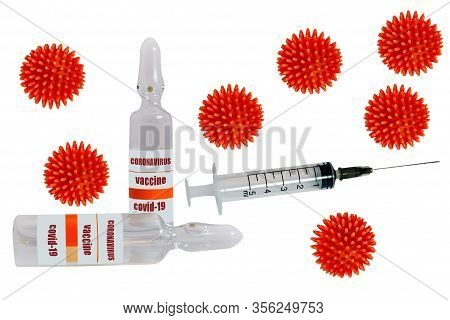 A Syringe And A Glass Ampoule With The Inscription Coronavirus Covid-19 Vaccine On The Background Of