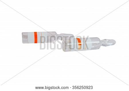 Glass Ampoules With The Inscription Coronavirus Covid-19 Vaccine On A White Background. Close-up.