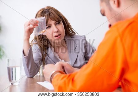 Young man meeting with advocate in pre-trial detention