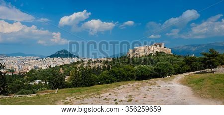 Panorama of famous greek tourist landmark - the iconic Parthenon Temple at the Acropolis of Athens as seen from Philopappos Hill, Athens, Greece