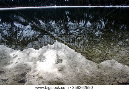 The Snowy Dolomites Are Reflected In The Calm Waters Of Lake Dobbiaco In Winter, Trentino Alto Adige