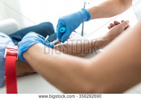 Senior man having a blood test done by a nurse