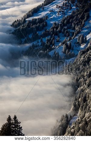 Splendid apline scenery. High mountains with fog and lovely evening light.
