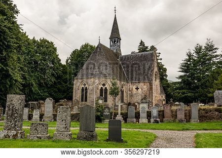 Luss, Scotland - August 1, 2019: Very Old Luss Parish Church Dedicated To Saint Kessog With A Gravey