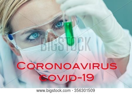 Female medical or research scientist or woman doctor looking at a test tube of in a Coronavirus COVID-19 vacine lab or laboratory with text