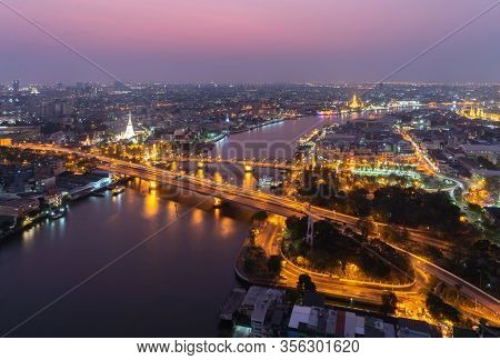 White Prayoon Pagoda, Memorial Bridge, And Phra Pok Klao Bridge With Buildings And Curve Of Chao Phr