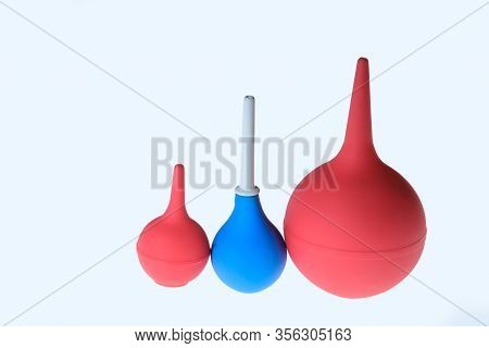 Red And Blue Enemas Isolated. Medical New Enema. Enema In Medicine. Different Sizes Of Enemas