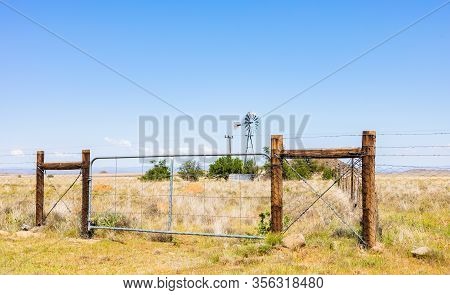 Windmill On A Farm In Rural Grassland Area Of South Africa