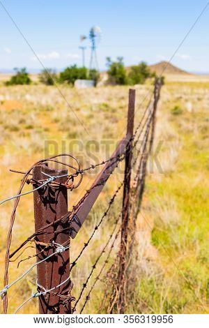 Windmill On A Farm In Rural Grassland Area Of South Africa