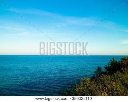 Baltic Sea From Cliff In Mechelinki, Poland. Nature And Travel Concept. Copy Space On Blue Sky.