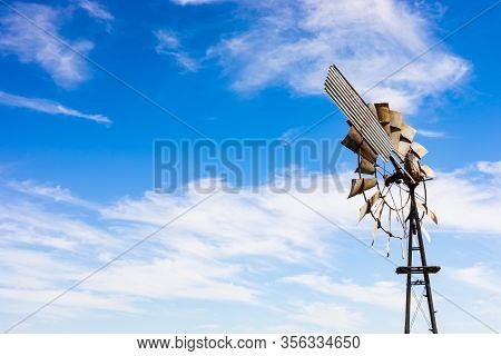 Windmill On A Farm In Rural Grassland Area Of South Africa