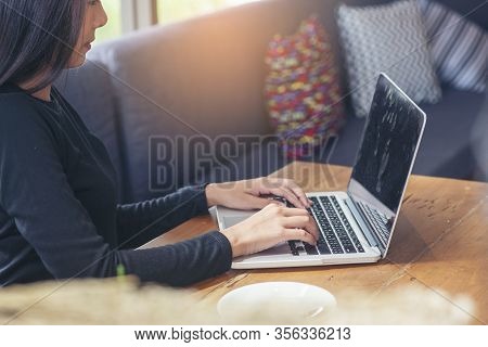 Business Woman Working On Laptop And Use Smartphone At Home Office,student Typing Report And Researc