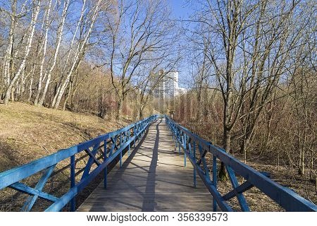 A Pedestrian Bridge Laid The Bottom Of A Small Ravine. Landscape Reserve 
