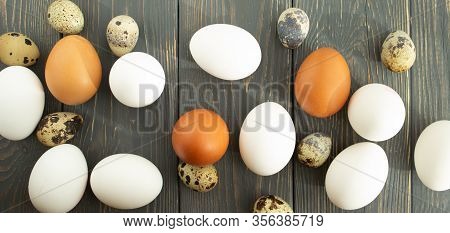 Easter. Chicken And Quail Eggs Of Natural Colors On A Wooden Background. Flat Lay