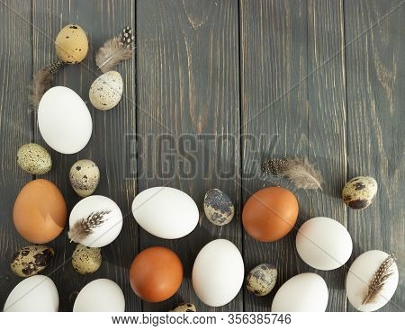 Easter. Chicken And Quail Eggs Of Natural Colors On A Wooden Background. Flat Lay