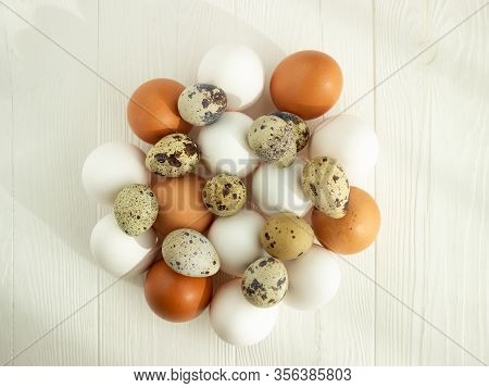 Easter. Chicken And Quail Eggs Of Natural Colors On A Wooden Background. Flat Lay