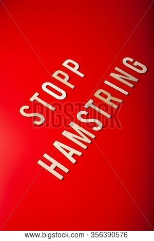 stopp hamstring norwegian word text wooden letter on red background coronavirus covid-19