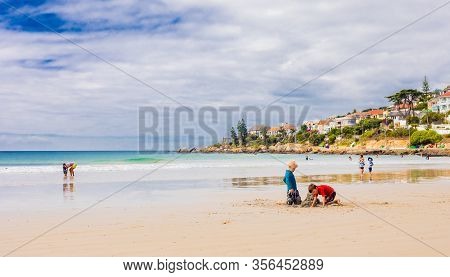 Kids Building Sand Castles On The Beach During School Holidays