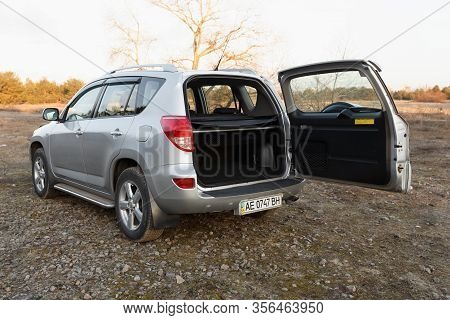 Dnipro, Ukraine - February 19, 2020: Toyota Rav4 2006 Gray Color With Open Trunk Near The Forest, Op