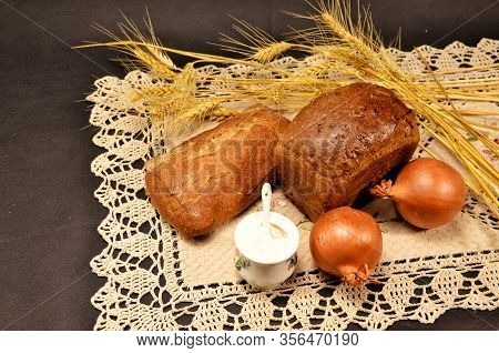 Rosy And Delicious Bread With Onions And Salt On A Linen Napkin