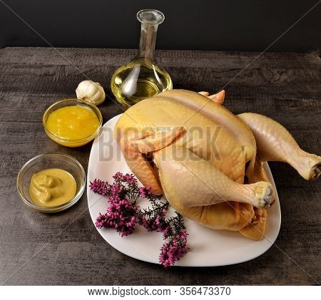 Delicious Chicken In A White Plate, Honey, Mustard And Butter On A Dark Table
