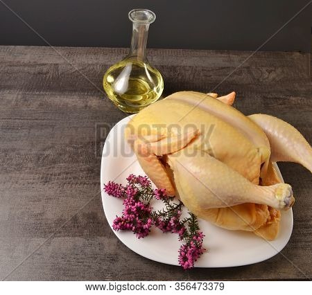 Delicious Chicken In A White Plate And Butter On A Dark Table