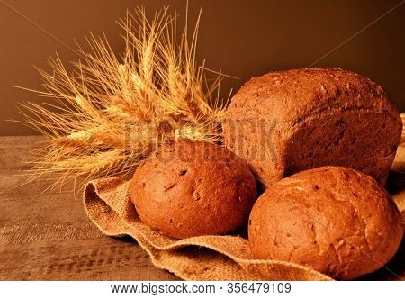 Rosy, Delicious Bread And Ripe Ears Of Wheat On A Jute Bag