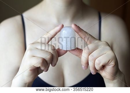 A Woman Holding A Natural Deodorant - Alunite Crystal, Natural And Therapeutic Cosmetics.