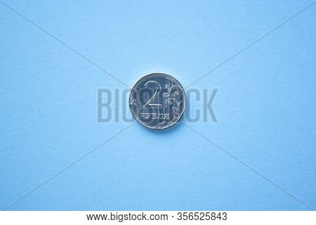 Coin Two Rouble On Bright Blue Background. Ruble Depreciation. Rouble To Dollar
