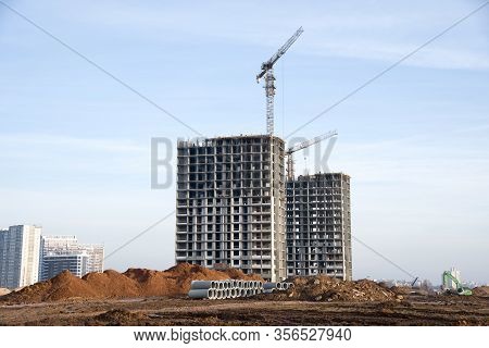 Tower Cranes Constructing A New Residential Build. Formwork Of Building At Construction Site. Laying