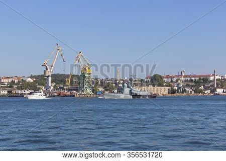 Sevastopol, Crimea, Russia - July 26, 2019: R-239 Missile Boat On The Background Of Tower Cranes Of 