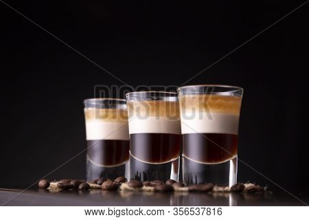 Low Angle View Of Three Shots Of B-52 Cocktail Placed On A Bar Counter