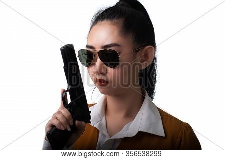Portrait Beautiful Asea Woman Wearing A Yellow Suit One Hand Holding Pistol Gun At The White Backgro