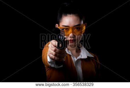 Women Pointing A Guns Look At The Camera, Portrait Beautiful Asea Woman Wearing A Yellow Suit One Ha