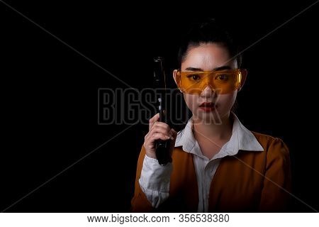 Portrait Beautiful Asea Woman Wearing A Yellow Suit One Hand Holding A Pistol Gun At Black Backgroun