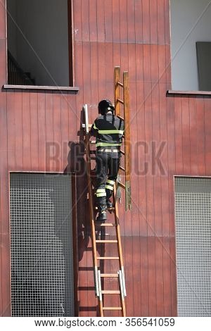 Firefighter On The Stepladder In The Fire Department During Practice