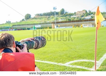 Photoreporter With Telephoto Lens On A Football Match