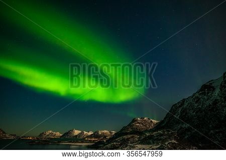 Polar Lights Aurora Borealis, Northern Lights, Over Mountains With Many Stars On The Sky In Lofoten 