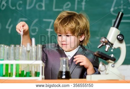 Small Boy Using Microscope At Lesson. Microscope At Lab. Back To School. Pupil Looking Through Micro
