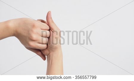Male Model Is Interlock Fingers And Rub Mid-joints On White Background.