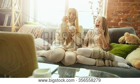 Home Comfort. Happy Loving Family. Mother And Daughter Spending Time Together At Home. Watching Cine