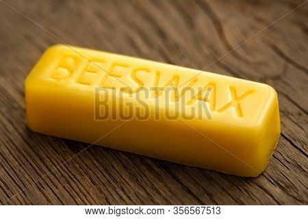 Beeswax Block On Wooden Background. Natural Beeswax.