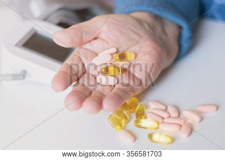 Elderly woman with pills hand, grandmother with medicines