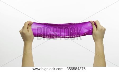 Woman Hands Playing With Oddly Satisfying Purple Slime On White Background. Sticky Gooey Substance. 