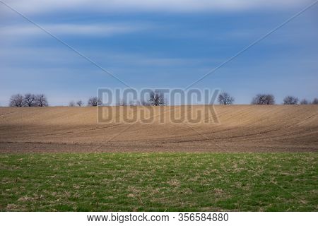 Panorama Of Arable Land Under Amazing Clouds